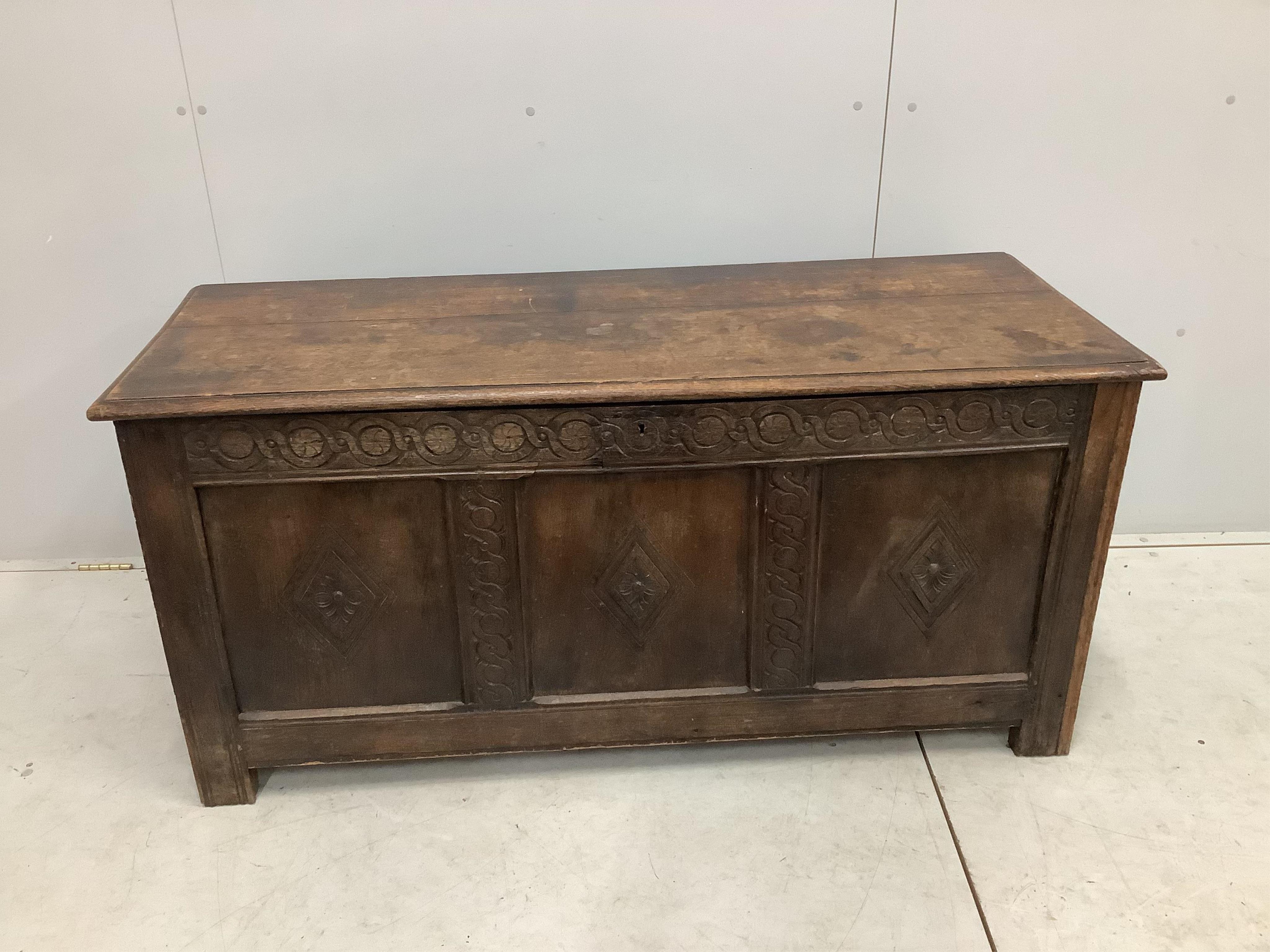 An 18th century carved oak coffer, width 141cm, depth 53cm, height 68cm. Condition - fair